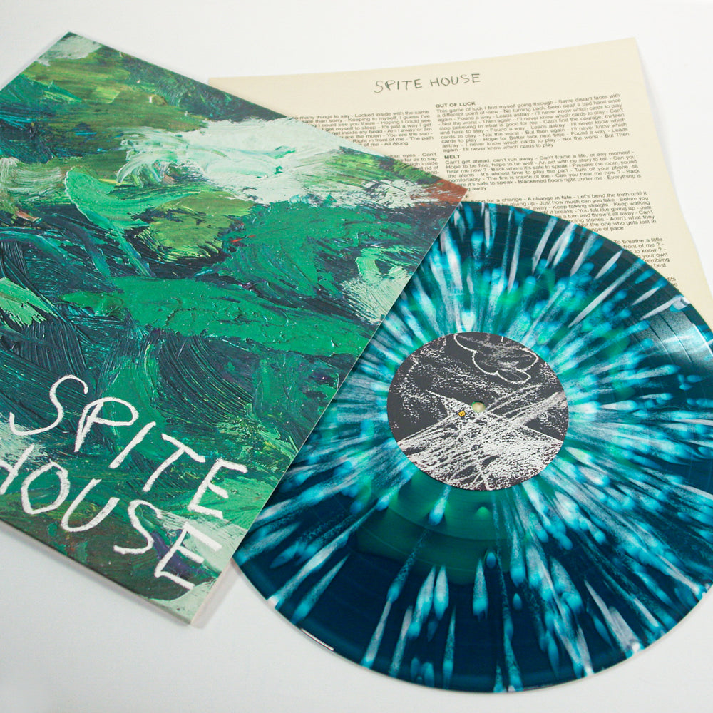 A green and white marbled Spite House vinyl LP lies beside its cover, featuring abstract green brushstrokes, handwritten “Spite House” text, and sea blue accents. Album releases September 2025.