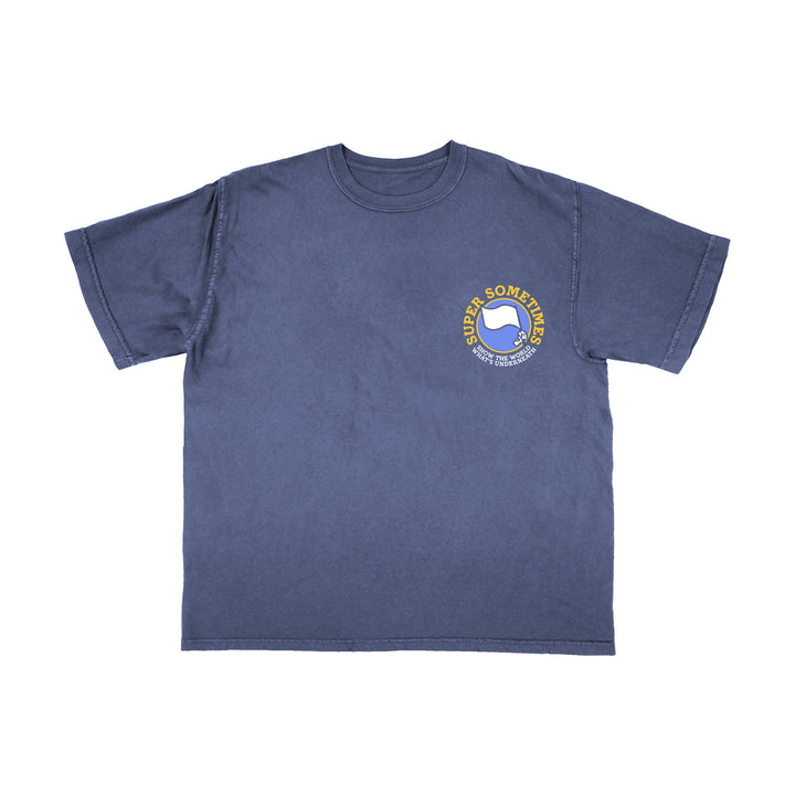 A blue Comfort Colors short-sleeve shirt by Super Sometimes featuring a small yellow and white circular chest logo with a thumbs-up graphic and the text “SUPER SOMETIMES.”.