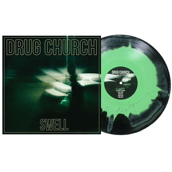 Drug Church’s “Swell” vinyl features a Swell Mint/Black/Olive marbled design. The album cover shows a blurry dark green street scene with bold Drug Church text. Release date: June 5, 2026.