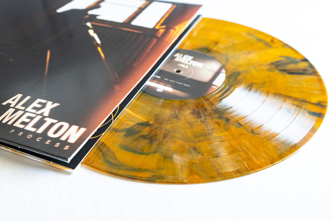 A yellow and black Tigers Eye Marble Vinyl LP by Alex Melton, partially out of its sleeve with the album name in bold white, is available now for presale.