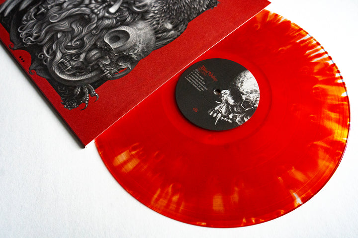 A translucent orange and yellow marbled Vinyl LP from Blood Vulture, partially out of its cloudy blood red sleeve featuring detailed black and white artwork of a bearded face. A must-have for Die Close fans.