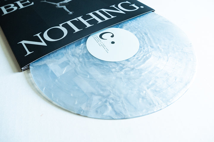 A translucent, marbled vinyl record from Boston Manor’s Be Nothing album partially slides out from a black and white sleeve featuring bold “NOTHING” text. The white label with minimal black text and a small circle complements Boston Manor’s distinct Be Nothing aesthetic.
