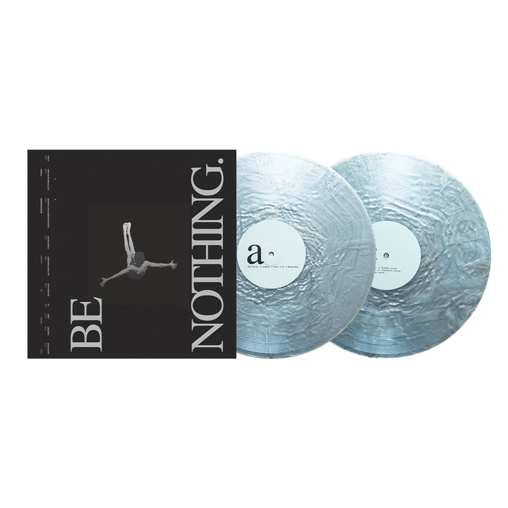 Album cover and two silver marbled vinyl records. The black cover features a grayscale image of someone diving with "BE NOTHING." printed in large white font. The partially overlapping records create a striking display—the perfect collector’s edition for fans celebrating the Boston Manor 10 Year Anniversary release of "Be Nothing" on vinyl.