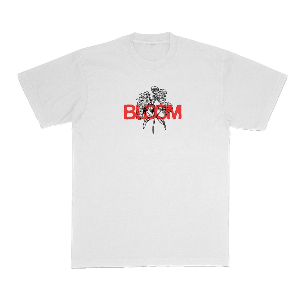 Bloom brand white t-shirt with a black floral line drawing on the chest and the word BLOOM in bold red capitals partially overlaying the flowers.