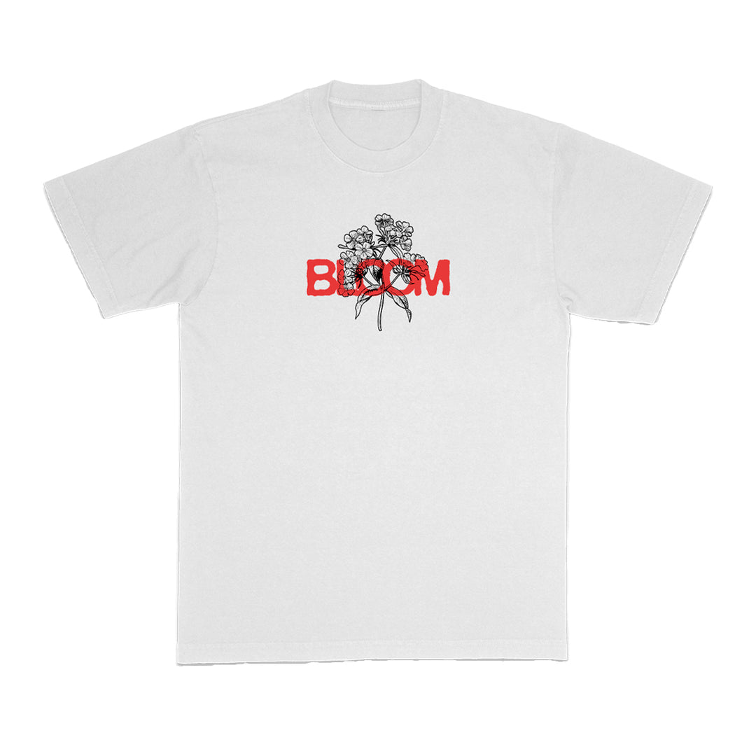 Bloom brand white t-shirt with a black floral line drawing on the chest and the word BLOOM in bold red capitals partially overlaying the flowers.