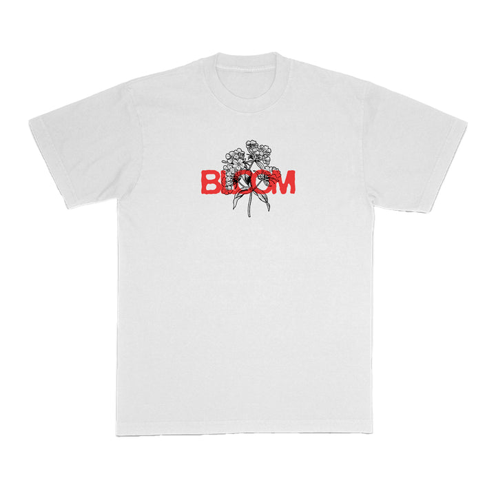 Bloom brand white t-shirt with a black floral line drawing on the chest and the word BLOOM in bold red capitals partially overlaying the flowers.