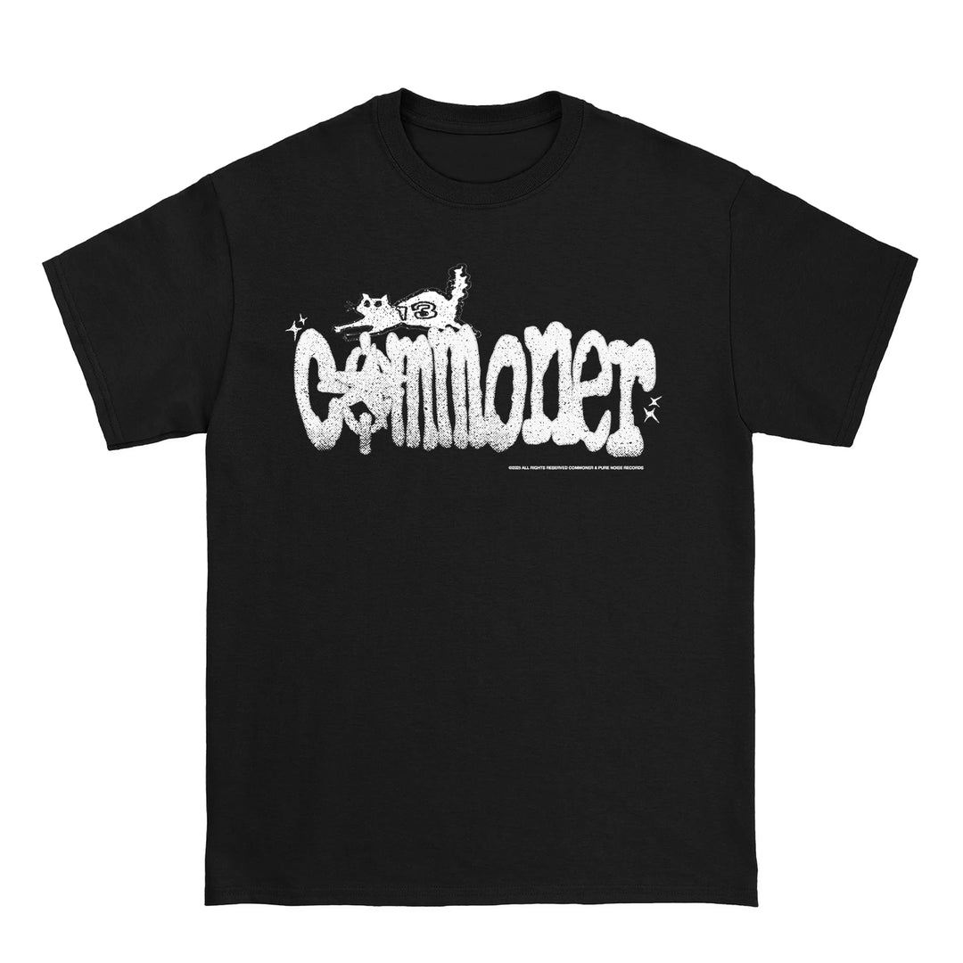 This black Hanes Beefy t-shirt by COMMONER features "Commoner" in bold white graffiti-style letters, topped by a playful cartoon cat and sparkling accents for added charm.