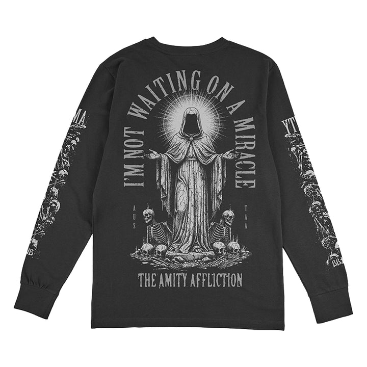 Black Gildan long-sleeve shirt by The Amity Affliction featuring a hooded, haloed figure with skulls and skeletons, plus “I’M NOT WAITING ON A MIRACLE” text.