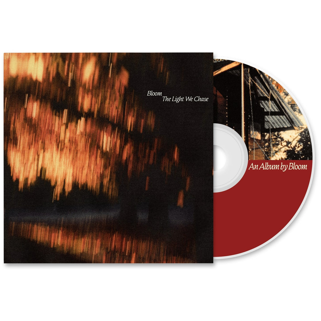 Bloom’s 2025 album The Light We Chase CD features striking red and white disc design and cover art with glowing orange-yellow lights, possibly sunset-lit trees.