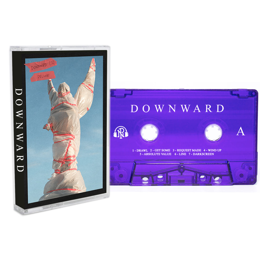 A Deluxe DOWNWARD Cassette Tape rests beside its case, which shows a statue wrapped in white plastic and red tape, topped with a red "DOWNWARD (21) DEMO" label—an ideal collectible for any DOWNWARD fan.