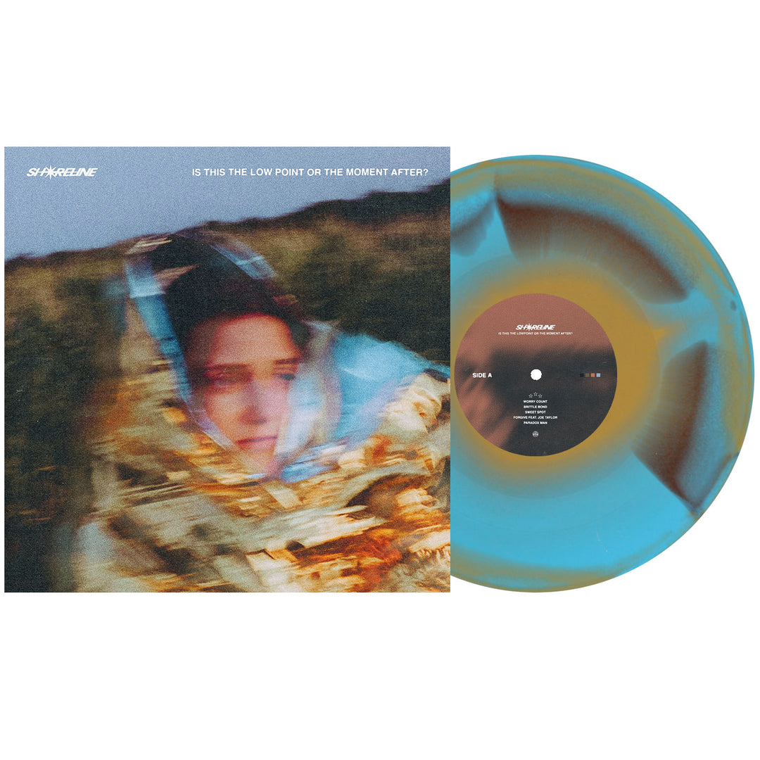 A blue and brown swirl vinyl LP from Shoreline sits beside its album cover, showing a blurred figure in a reflective blanket outdoors. The presale album is titled "Is This the Low Point or the Moment After?".