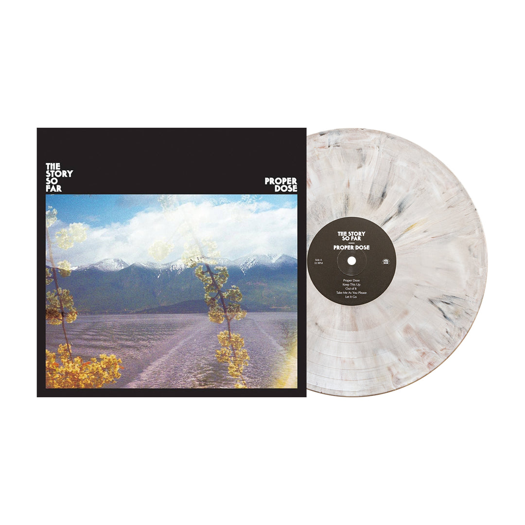 The Story So Far’s Proper Dose 7th pressing collectible includes a marbled white limited edition vinyl and album cover with scenic mountains, blue sky, and yellow flowers.