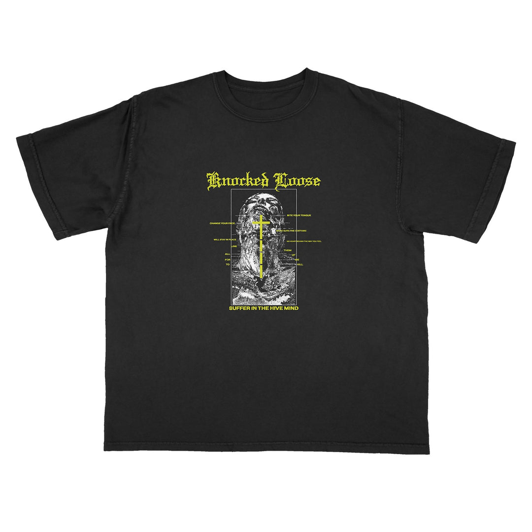 Knocked Loose black LA Apparel t-shirt with a gothic-style yellow cross on a grayscale scene, yellow Knocked Loose text above, and “Suffer In The Way You Live” below—ideal for fans of bold graphic tees.
