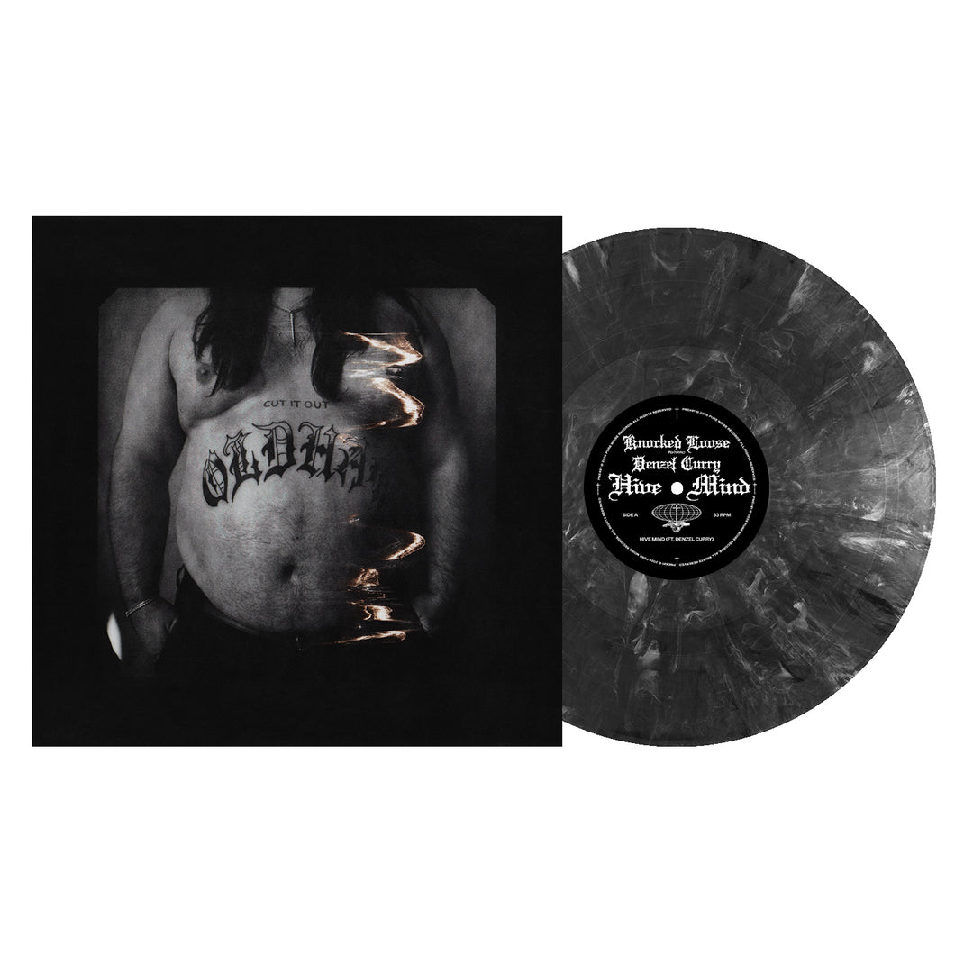 A black and gray onyx marble vinyl record by Knocked Loose sits beside its album cover, featuring a close-up of a tattooed torso with "OLDIE" inked across the stomach—a striking collectible for any fan.