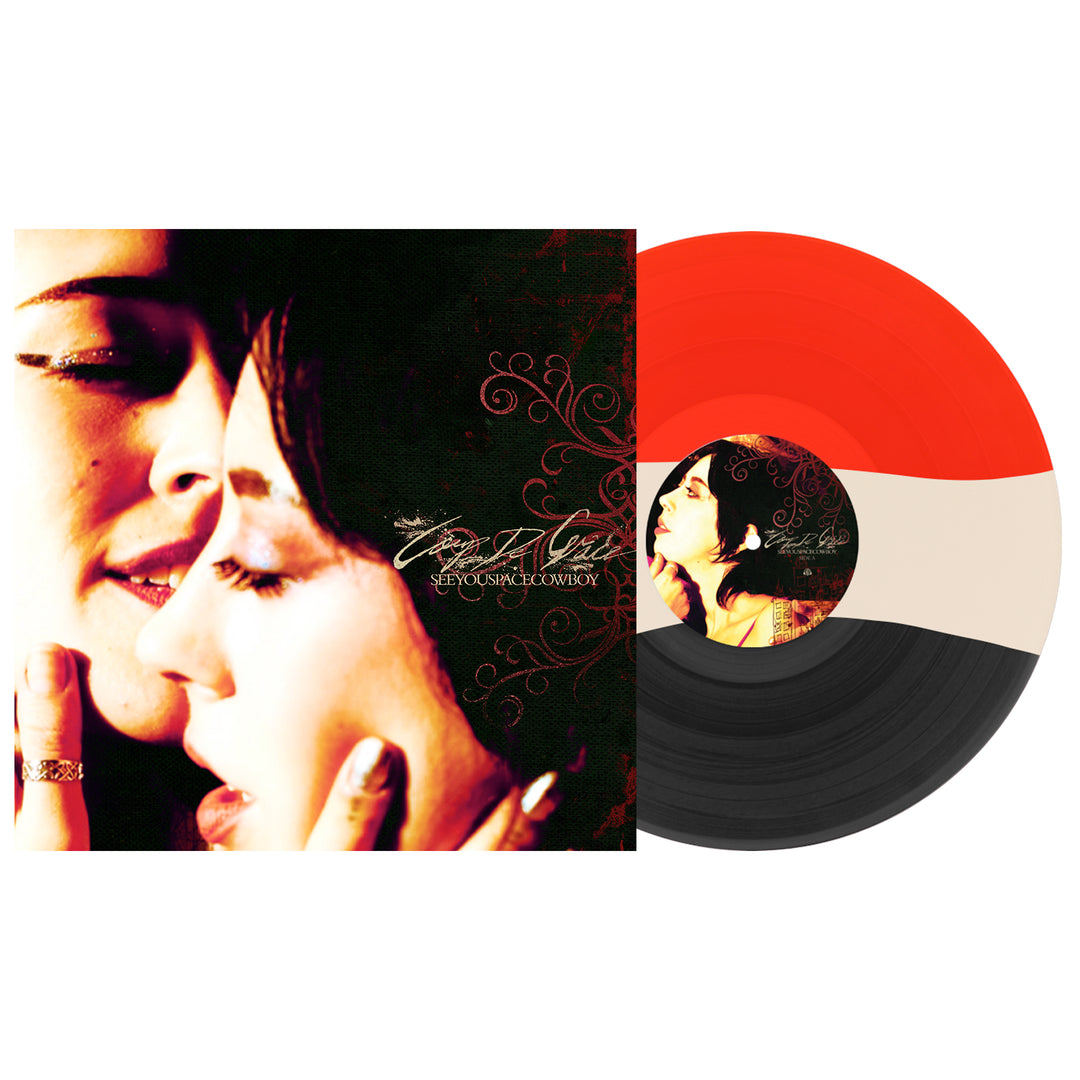A Blood Red, Tri-Stripe vinyl by SeeYouSpaceCowboy is displayed beside its album cover, which shows a close-up of two women’s faces touching intimately against a dark background.
