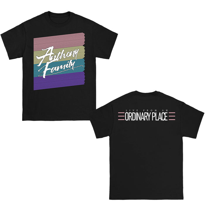 Anthony Family black tee featuring a colorful striped square and “Anthony Family” script on the front; back shows “LIVE FROM AN ORDINARY PLACE” in bold white uppercase with pink accent lines.