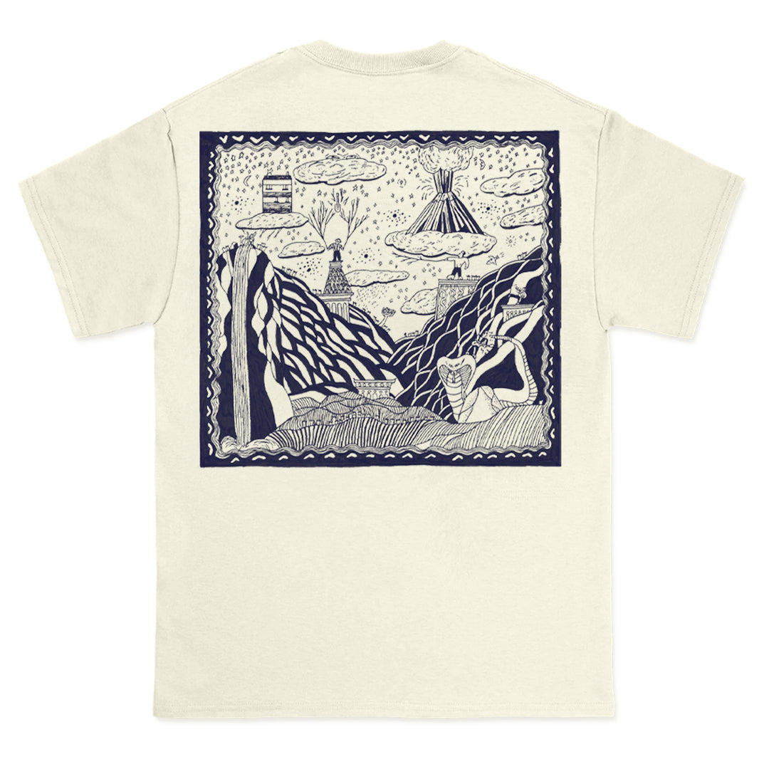 Cream-colored Comfort Colors t-shirt by The Story So Far, featuring a large navy-outlined graphic on the back with a whimsical, hand-drawn scene of mountains, clouds, trees, and a tent among abstract nature elements.