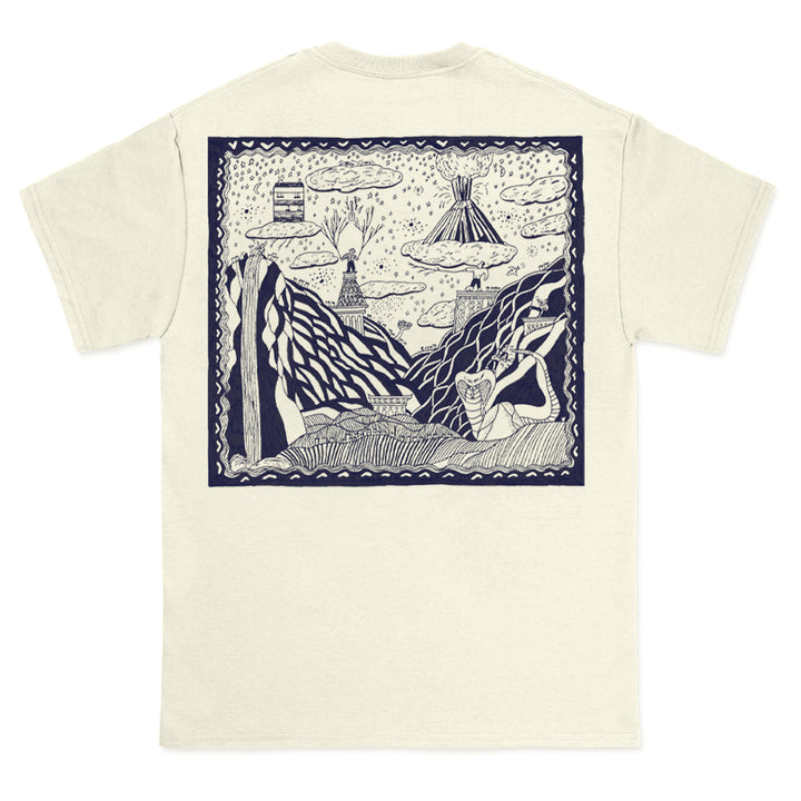 Cream-colored Comfort Colors t-shirt by The Story So Far, featuring a large navy-outlined graphic on the back with a whimsical, hand-drawn scene of mountains, clouds, trees, and a tent among abstract nature elements.