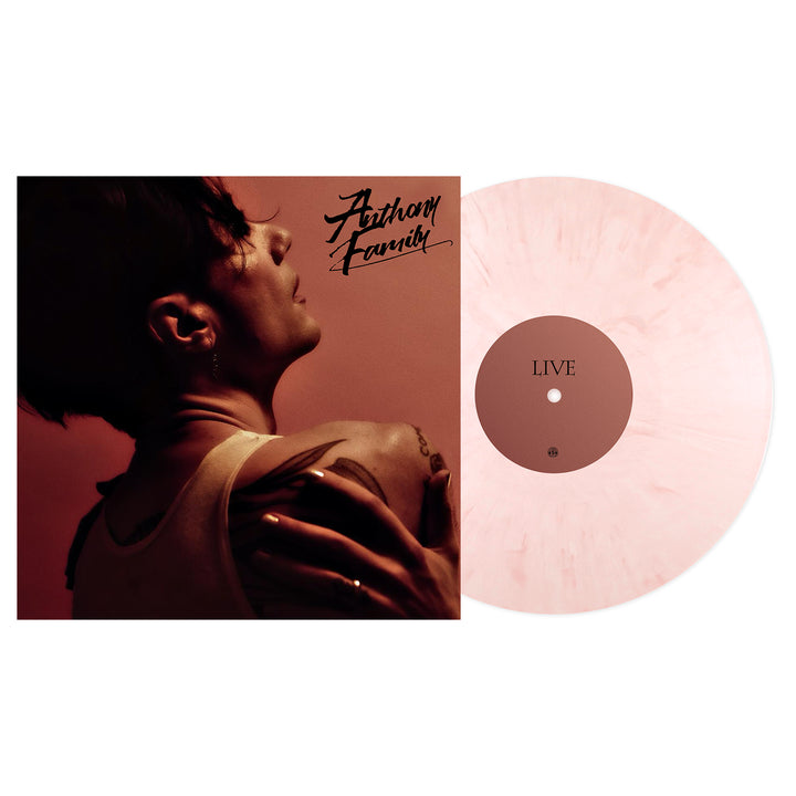 A Guava Cream Vinyl with a light pink marbled design sits beside its Live From An Ordinary Place album cover, featuring a tattooed person looking upward and Anthony Family in cursive at the top. Releasing August 2025.