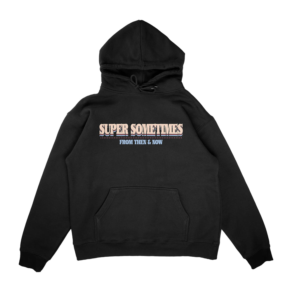 A Super Sometimes black hoodie with a front pocket features bold white and pink SUPER SOMETIMES text on the chest, with FROM THEN & NOW in smaller blue letters beneath.