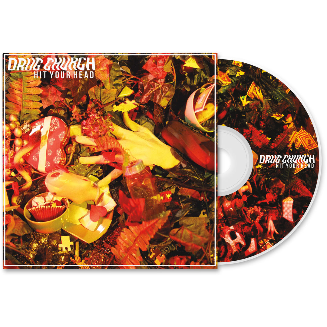Drug Church “Hit Your Head” presale CD with album cover featuring a chaotic collage of red, yellow, and green objects—gloves, toys, and foliage—all in a vibrant composition to mark the release.