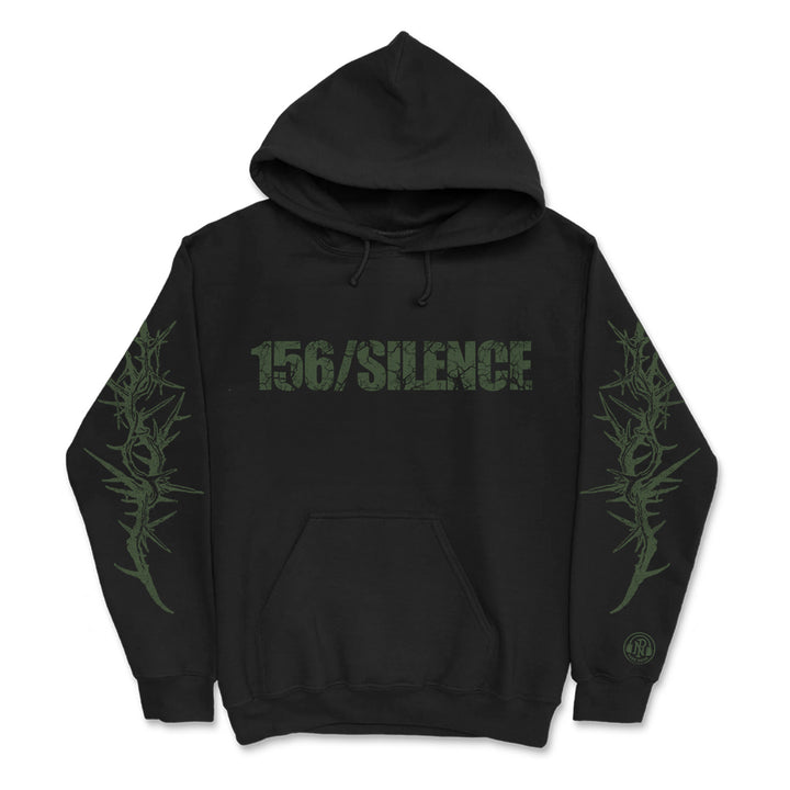 Black hoodie by 156/Silence with distressed green 156/SILENCE text on the chest, abstract green thorn designs on both sleeves, and a small round logo near the left wrist.
