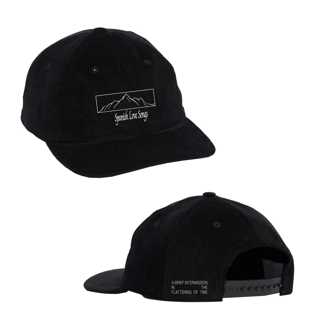 A black corduroy snapback hat by Spanish Love Songs, shown front and back. The front displays embroidered mountains with the brand name, while the back features "A Brief Intermission, a Flattening Of Time" in white.