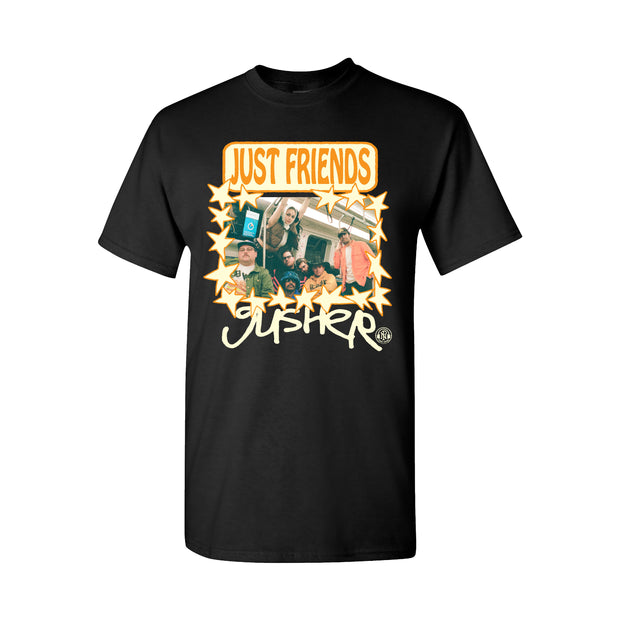 Just Friends Gusher Black T-Shirt. The center chest has a picture of the band on a subway together in color with a star border. the text Just Friends in orange bubble letters above the image and the text gusher in handwriting style text in white ink.