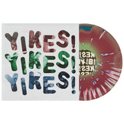 Dollar Signs YIKES vinyl LP, with the vinyl exposed to show color. Album art is the text YIKES! repeated 3 times in red, green, then blue with a white background. color of vinyl is Blue, Oxblood, Green Aside/Bside with White Splatter.