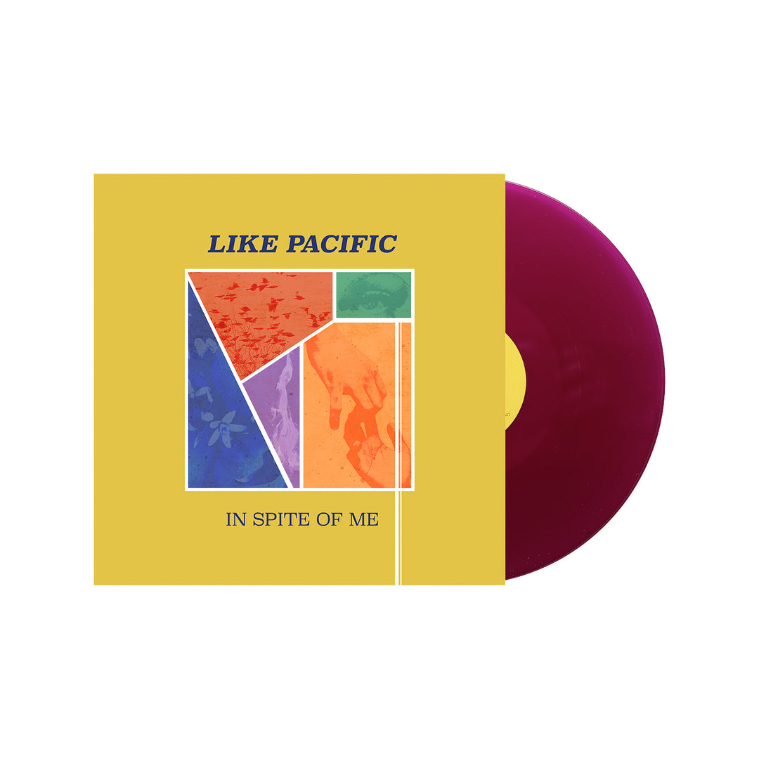 A maroon vinyl LP partially slides out of a yellow album cover. The Brand Name "Like Pacific" and the title "In Spite of Me" appear on the cover, with colorful abstract shapes and a tracklist included inside.