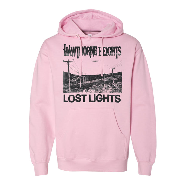 Hawthorne Heights Lost Light Pink Hoodie. front chest of hoodie has a valley with telephone poles going through it. above the image says Hawthorne Heights in their classic font. under the image says Lost Lights all of this is in black ink. 