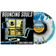 The Bouncing Souls Ten Stories High Vinyl LP. Album Art depicts a person sitting by the window looking out to see a large Bouncing Souls symbol floating in the sky. LP is exposed to show color. Side A Color of LP Black/White/Blue Aside/Bside with white and yellow splatter.