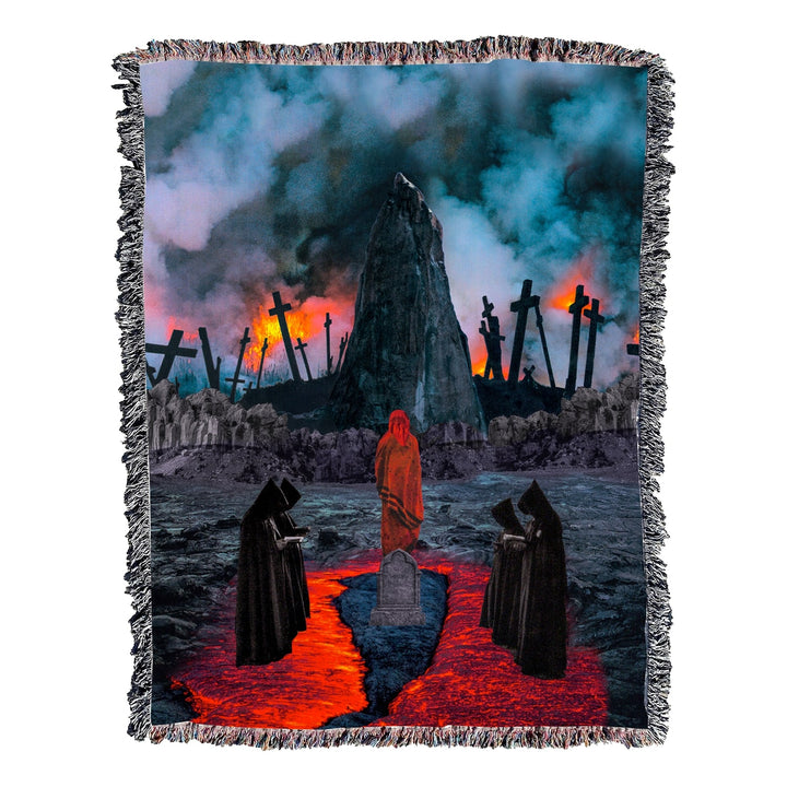 image of a woven blanket spread out flat to show entire image. Image on blanket is 5 spooky monks praying by a grave in pools of blood with the backdrop of many burning crosses.