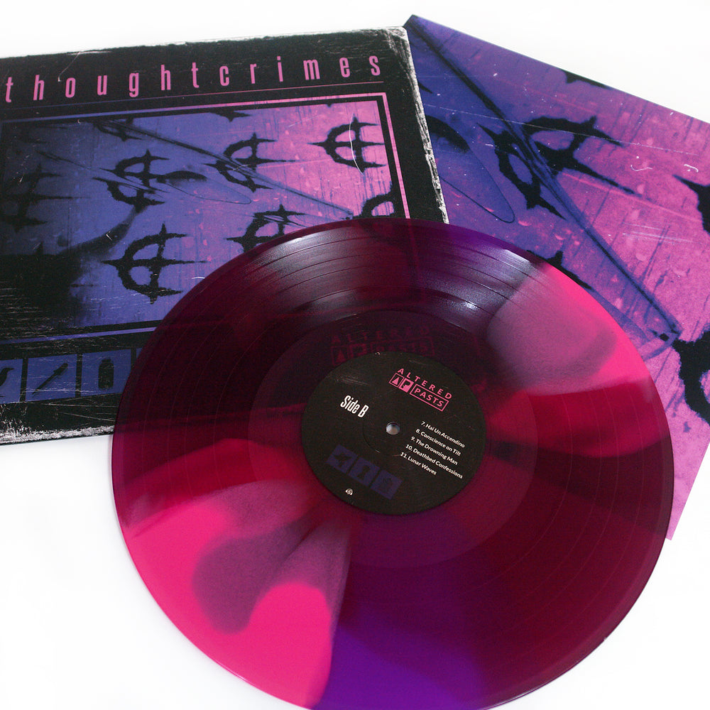 A translucent Deep Purple Hot Pink marbled vinyl record sits next to its album cover, which is black and purple with abstract designs and the word thoughtcrimes at the top.