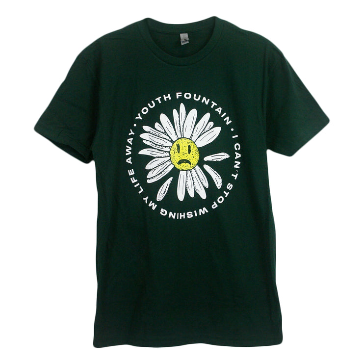 image of a forest green tee shirt on a white background. tee has a front and center print in white of circle text that says youth fountain, i can't stop wishig my life away. inside of the circle is a daisy flower with a yellow sad face in the center.