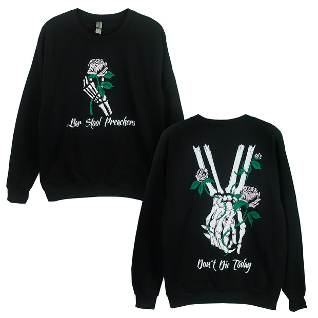 Dont Die Today Black Crewneck. Skeleton hand holding a pink rose with the text Bar Stool Preachers under it on the front. two skeleton hands, holding hands with 3 pink roses wrapped around them with the text Dont Die Today under it on the back. 