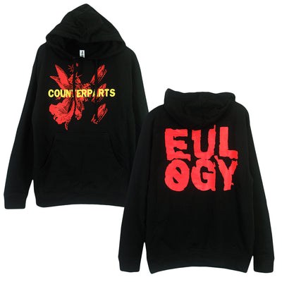 image of black pullover sweat shirt. front print has an angel with 3 coffins next to it in red ink. Over the image is "Counterparts" in yellow ink. the back print of the hoodie is the word "Eulogy" in red block letters. 