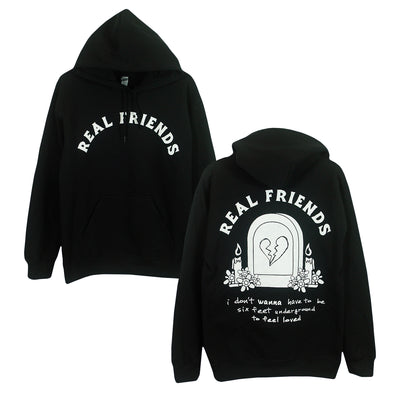 front and back of Real Friends Grave Black Pullover. Front of hoodie has Real Friends Text in white arched slightly across the chest. back of hood has a grave with candles and flowers around it with real friends text arched slightly above grave and Six Feet lyrics below the grave all in white text. 