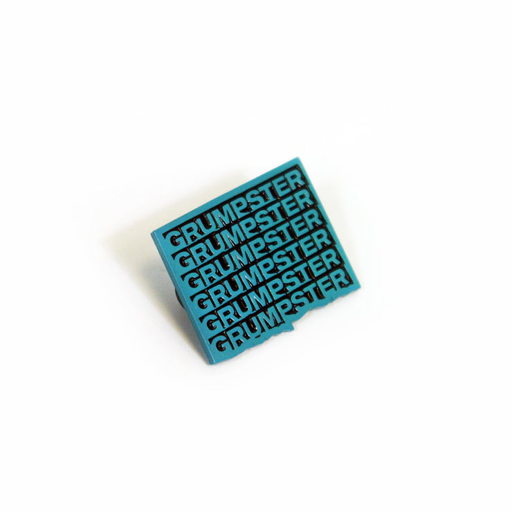 Image of Grumpster enamel pin on white background. Pin reads "Grumpster" in blue text repeating 6 times in a square design. 