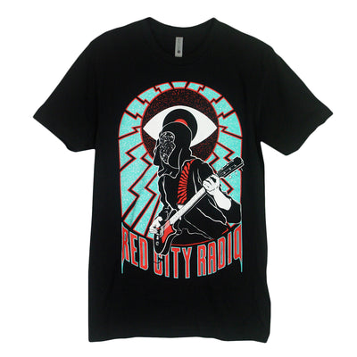 image of the front of a black tee shirt on a white background. tee has full body print of a guitar player in front of a giant eye ball with blue zig zags around and in red at the bottom says red city radio