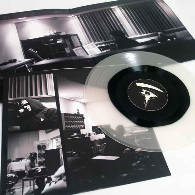 image of Halo Of Hurt Black In Milky Clear vinyl record on a white background. image shows insert and gate fold open up with record laid on top. there are black and white images of the band in the studio.