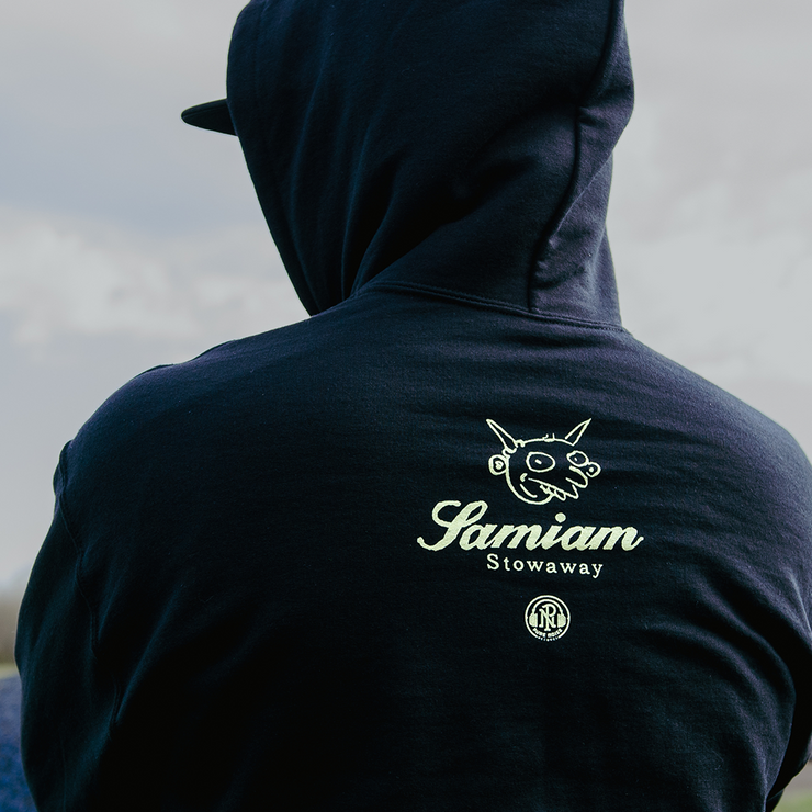 image of the back of a man wearing a black pullover hoodie. back of pullover has pure noise and Samiam Logo by the top center of the pullover. Left sleeve has the word Stowaway printed in yellow down the entire sleeve.