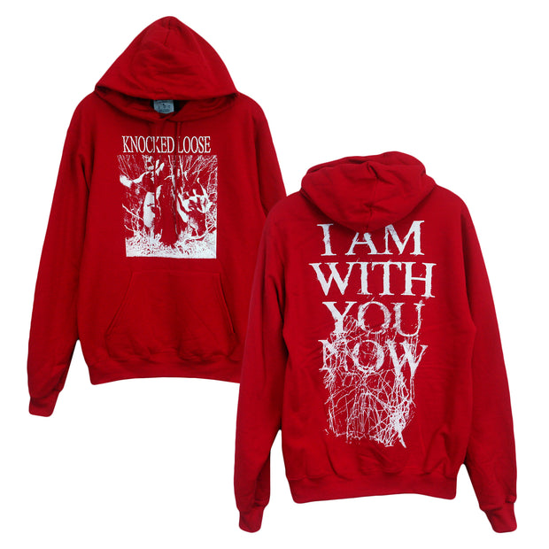 image of the front and back of a red pullover hooded sweatshirt on a white background. front of the hoodie is on the left and has a full chest print in white. above the front pouch pocket. Knocked loose is written at the top and below that is an image of a persons face with sunglasses on and hands up with white scribbles surrounding it. The back of the hoodie is on the right and has a full back print in white that says i am with you now and has white scribbles.