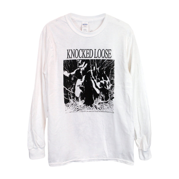 image of the front of a white long sleeve tee shirt on a white background. tee has a full chest print in black. Knocked loose is written at the top and below that is an image of a persons face with sunglasses on and hands up with white scribbles surrounding it. 