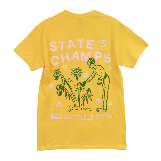image of the back of a yellow tee shirt on a white background. the back of the tee has a full back print. in light pink says state champs above a green outline of a woman trimming a dead plant above light pink text that says keep trying but nothing's good enough i guess were out of touch