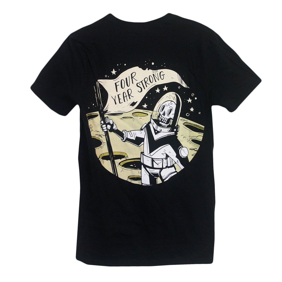 Black Gildan t-shirt by Four Year Strong featuring a cartoon astronaut with a band flag on a cratered yellow moon background. This tee combines comfort and style for any fan.