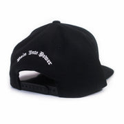 image of the back of a black snapback on a white background. the back of the hat has arched white embroidery above the back snap area that says pain into power.