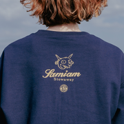image of the back of a girl wearing a navy crewneck sweatshirt.  back by the top center has the Pure noise and Samiam logo in gold 