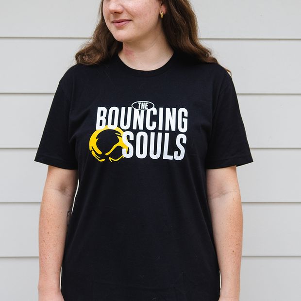 image of a woman wearing a black tee shirt. Front of shirt has "The Bouncing Souls" text in white in the center chest, with the bouncing souls logo right next to it