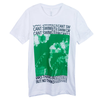 Can't Swim Thanks But No Thanks White T-Shirt. Center of shirt is a person with a few flowers surrounding them that turns into clouds by their head in green ink. Above that is "Cant Swim" text in a collage format in black ink. Below image is "Thanks But No Thanks" text in collage format in black ink. 